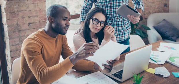 people sitting at a table reviewing document