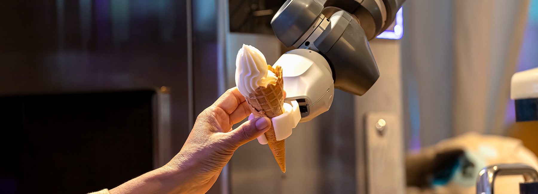 Robot Arm Preparing Ice Cream Cone Serving In The Cafe
