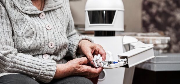 autonomous caregiver robot is holding a insulin syringe, giving it to an senior adult woman in her living room, concept ambient assisted living